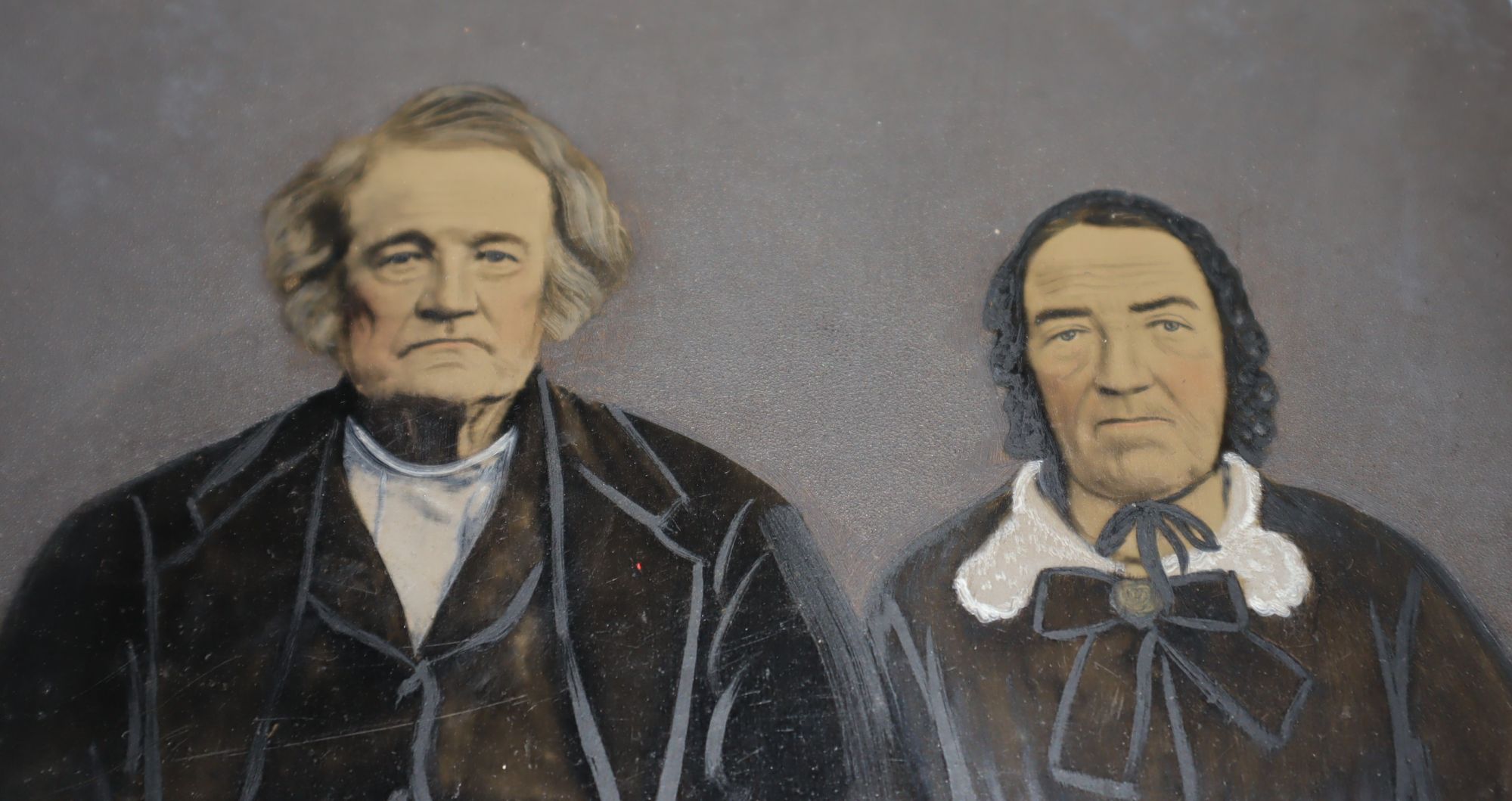 Large Photo on Tin of an Dour Older Couple, with a good amount of coloring