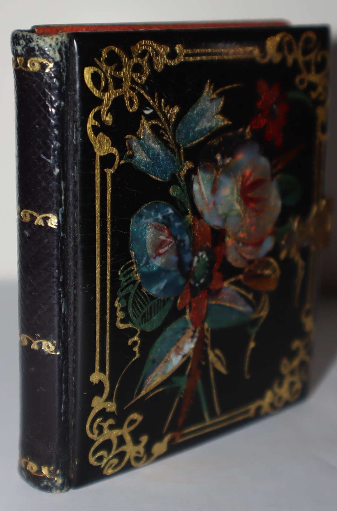 Small daguerreotype of a woman in an exquisite paper mache and mother-of-pearl case