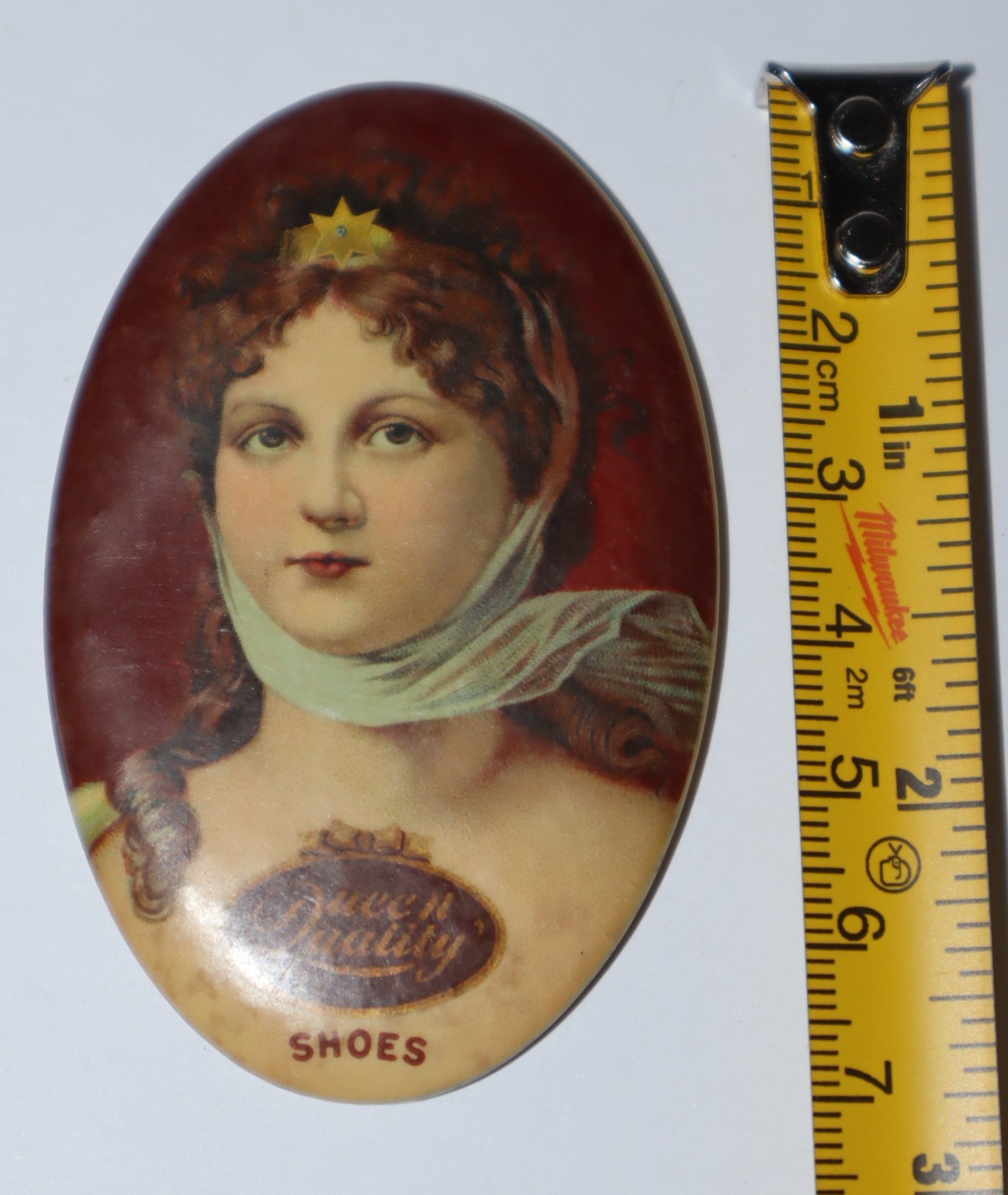 Queen Quality Shoes button-like promotion. Cameo portrait of Queen Louise of Prussia. Small oval pocket mirror on flip side